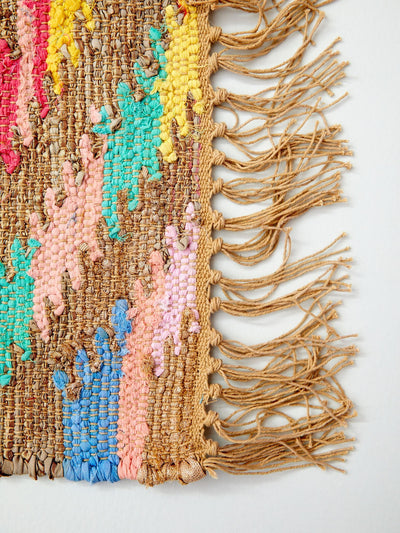  Colorful rug with fringes, perfect for adding a pop of color and texture to any room decor.